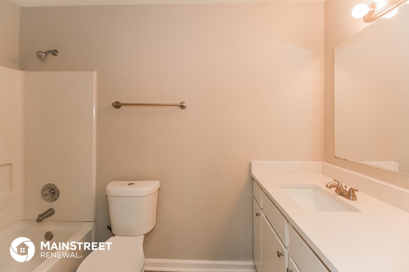 a bathroom with a toilet and a sink and a mirror
