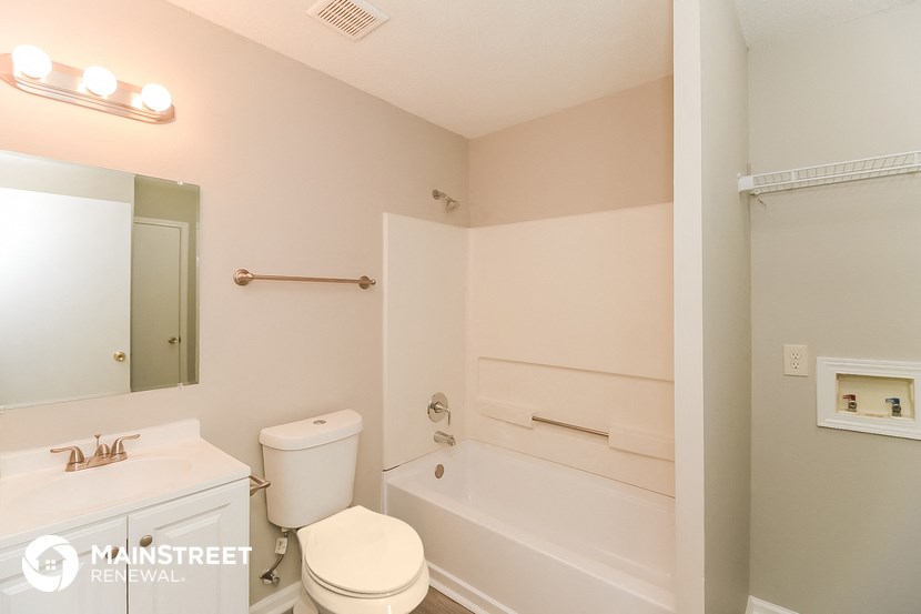 a bathroom with a tub and a toilet and a sink