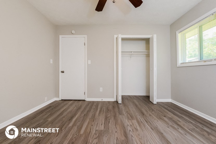 the master bedroom has a large closet and hardwood floors