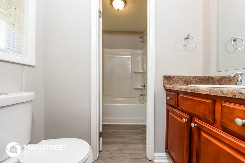a bathroom with a toilet and a sink and a shower