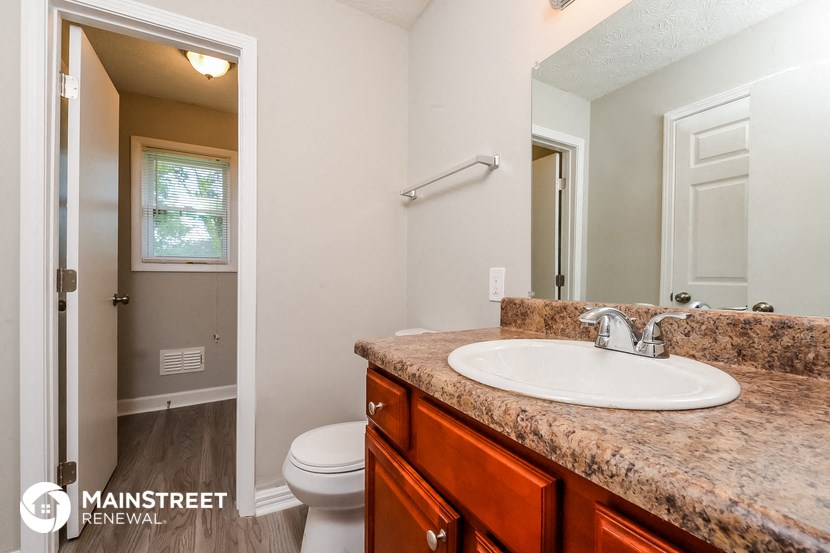 a bathroom with a sink and a toilet and a mirror
