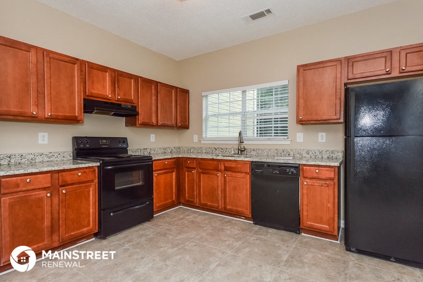 a kitchen with black appliances and wooden cabinets