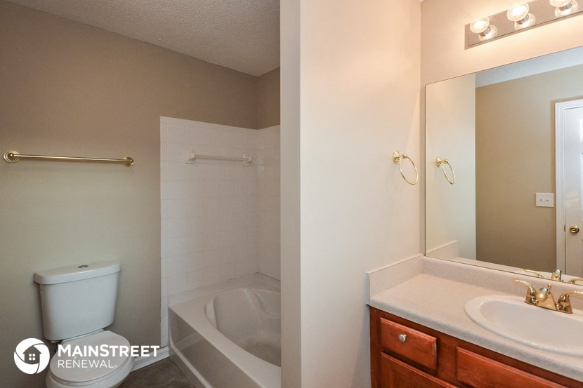 a bathroom with a sink and a toilet and a shower