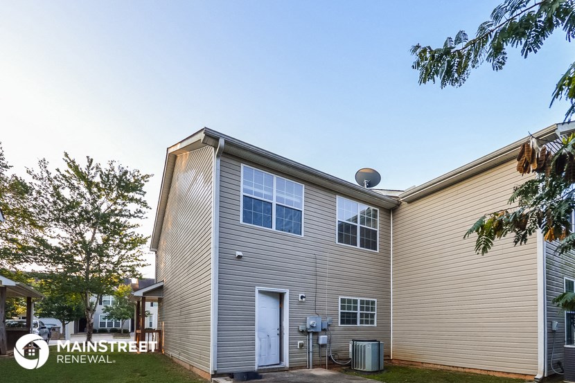 the exterior of an apartment building with a blue sky