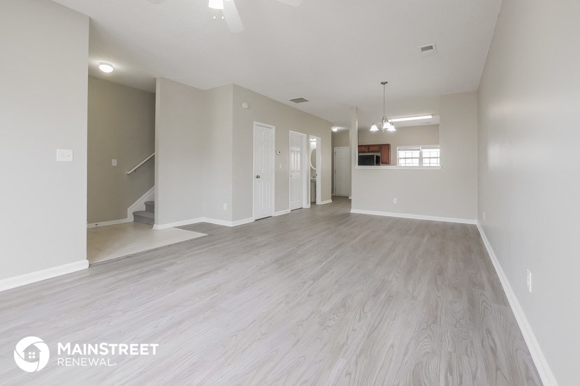 the living room and dining room of an apartment