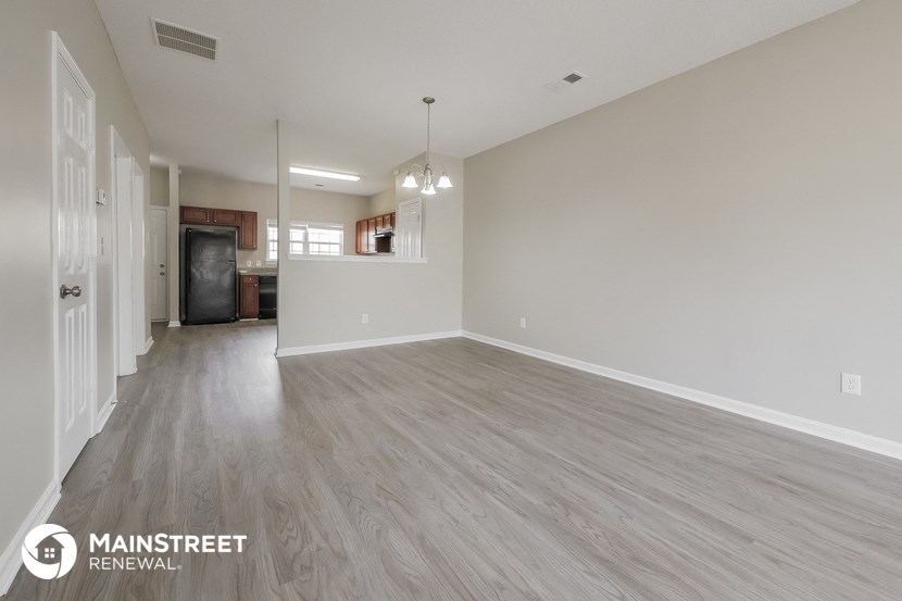 the living room and dining room of an apartment