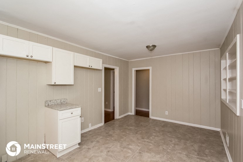 a kitchen with white cabinets and a white counter top
