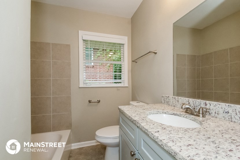 a bathroom with a toilet and a sink and a mirror