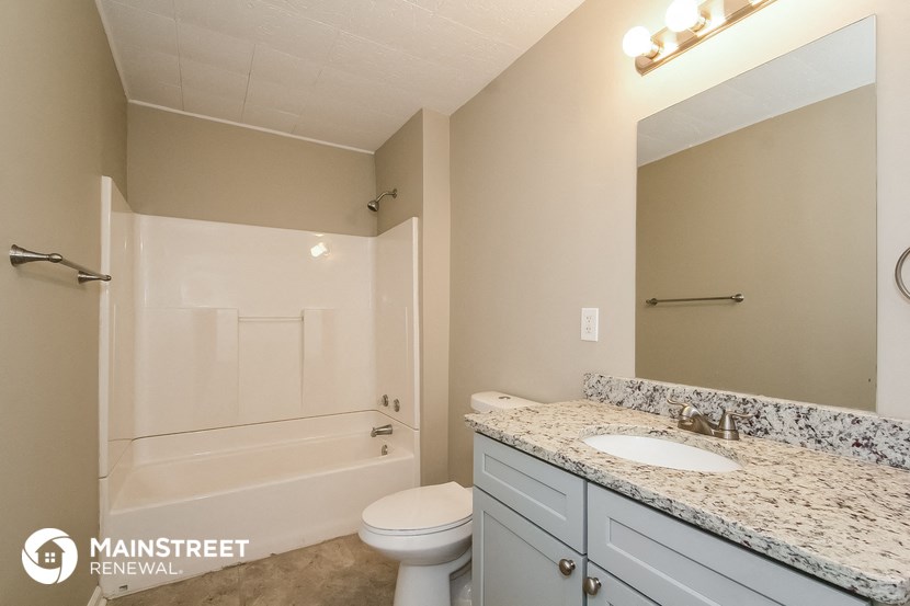 a bathroom with a sink and a toilet and a shower