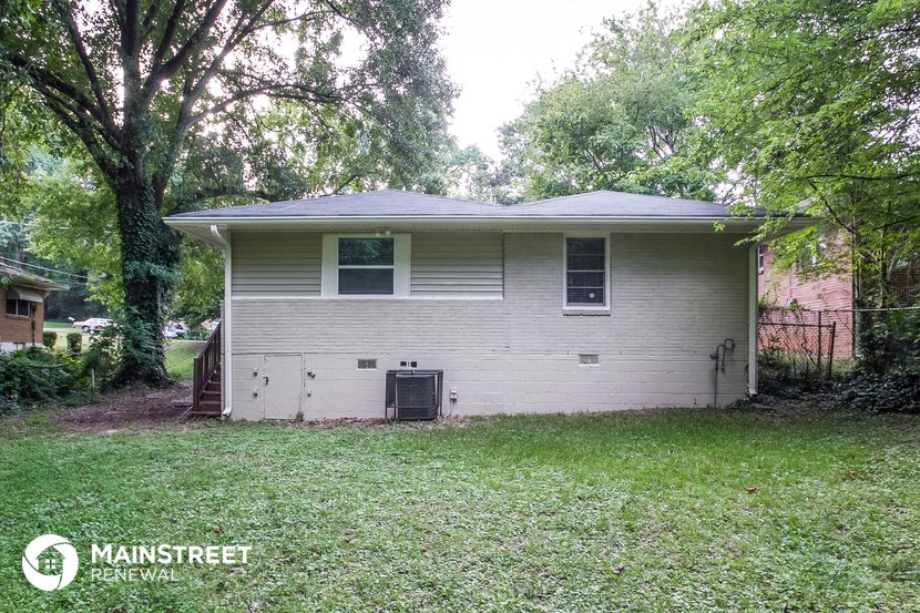 a white house with a yard and some trees