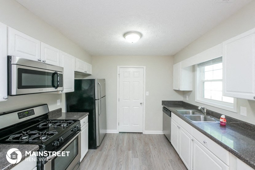 a kitchen with stainless steel appliances and white cabinets