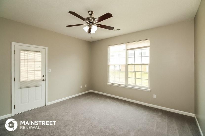 the master bedroom has a ceiling fan and a carpeted floor