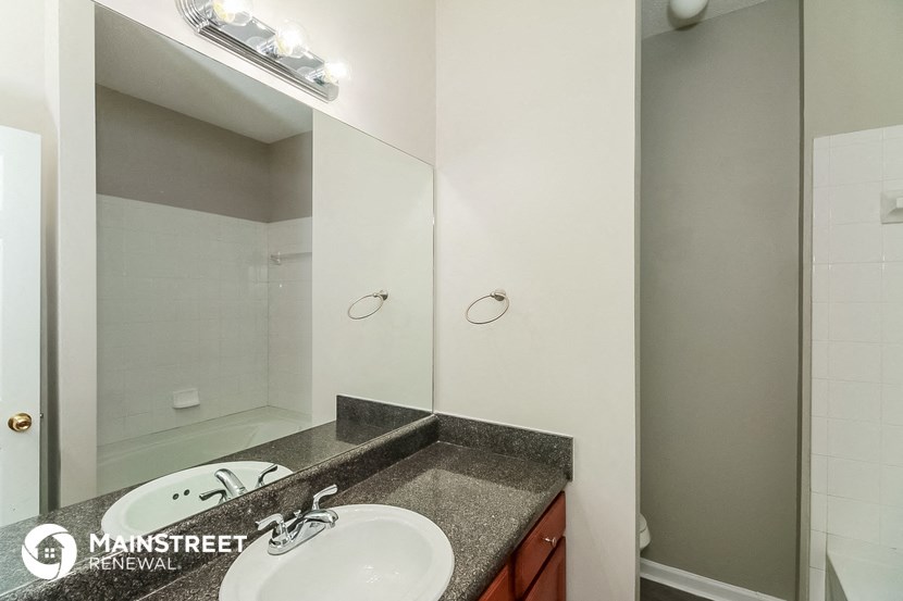 a bathroom with a sink and a mirror and a shower