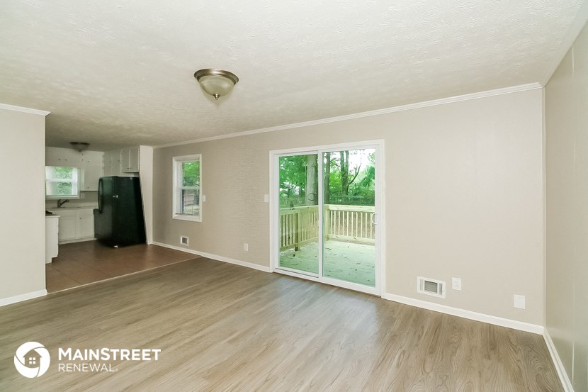 a living room with a sliding glass door to a porch