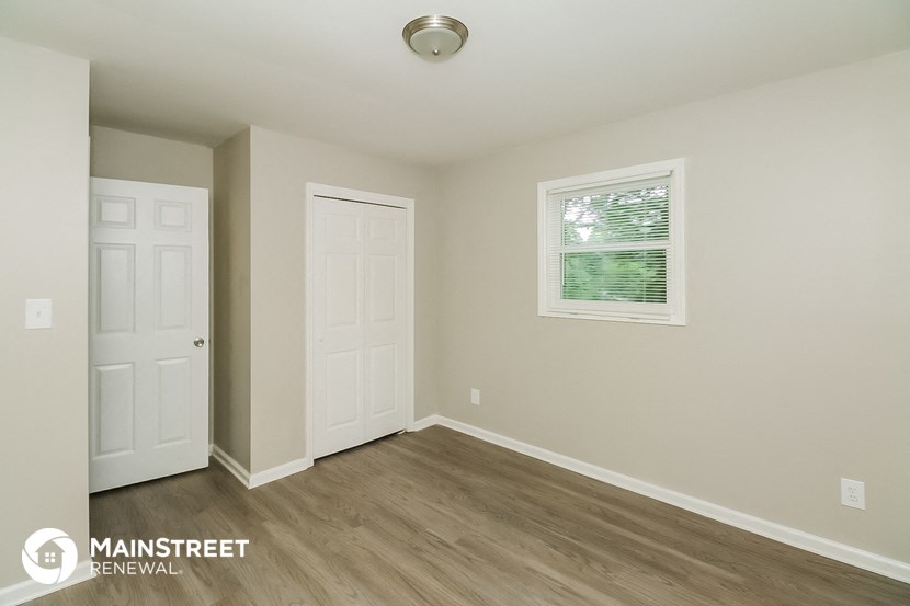 the upstairs bedroom has a door to the closet and a window