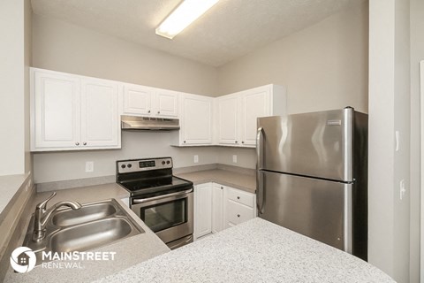 a kitchen with stainless steel appliances and white cabinets