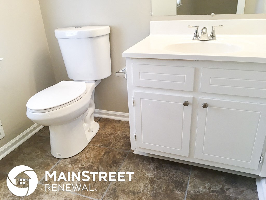 an image of a bathroom with a toilet and a sink
