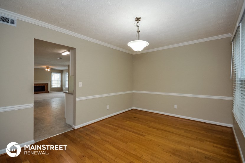 the dining room and living room of a renovated house