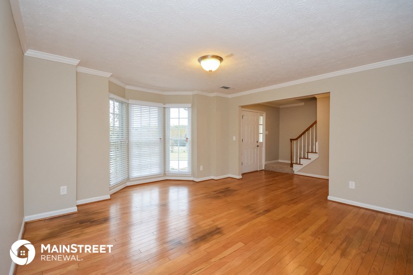 the living room and dining room with hardwood flooring