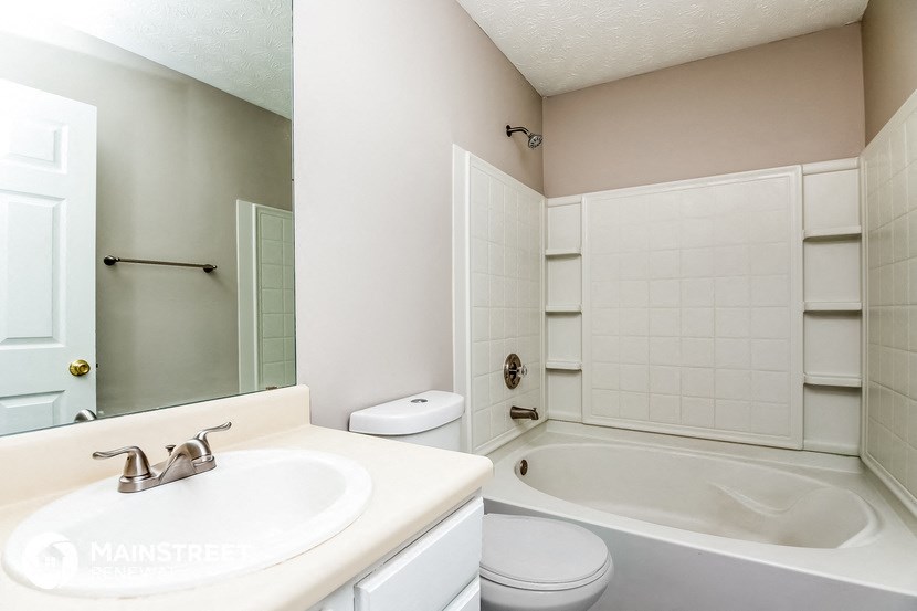 a bathroom with a sink toilet and a tub