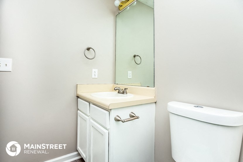 a bathroom with a sink and a mirror and a toilet