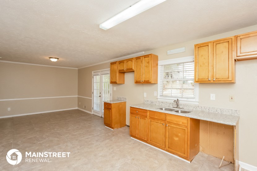 a kitchen with wooden cabinets and a sink and a counter top