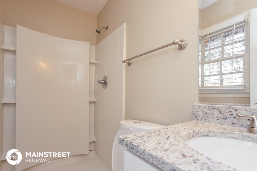a bathroom with a sink and a toilet and a shower