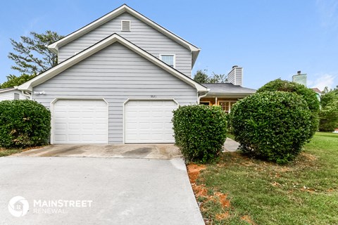 a white garage door in front of a house