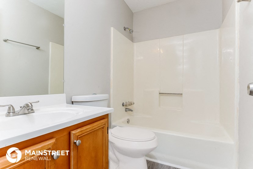 a bathroom with a sink toilet and shower and a bath tub