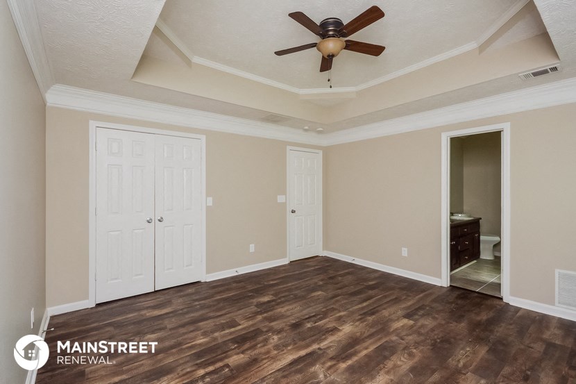 the living room of a new home with a ceiling fan