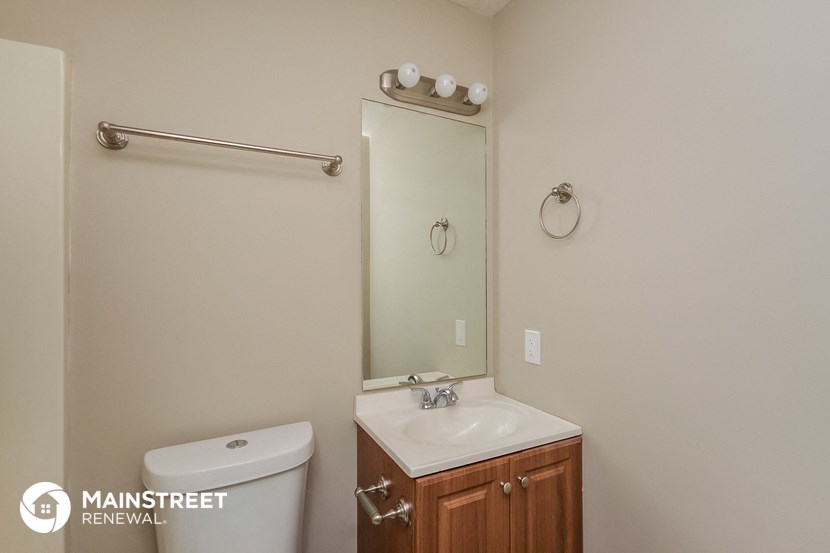 a bathroom with a sink and a mirror and a toilet