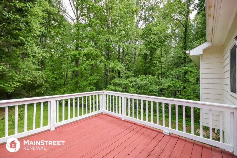 a white deck with a forest in the background