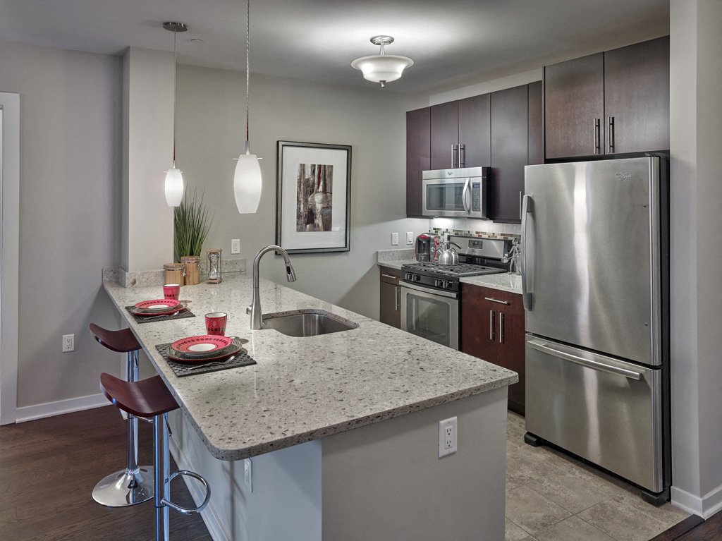 a kitchen with stainless steel appliances and granite counter tops