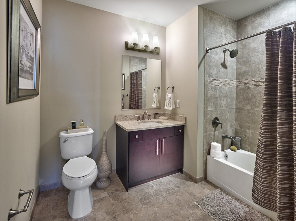 a bathroom with a toilet and a sink and a shower