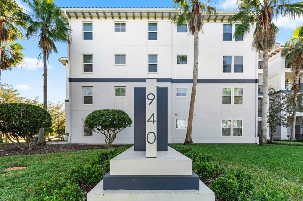 A white building with a number 40 on a pedestal in front of it.