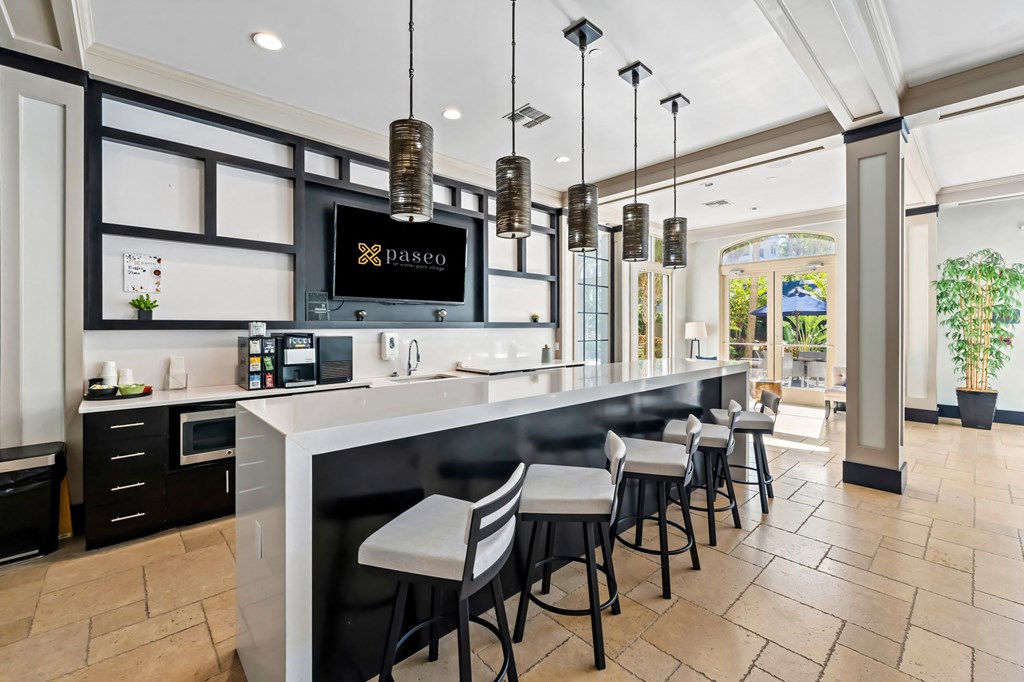 A modern kitchen with a bar area and a sign that says Pasco.