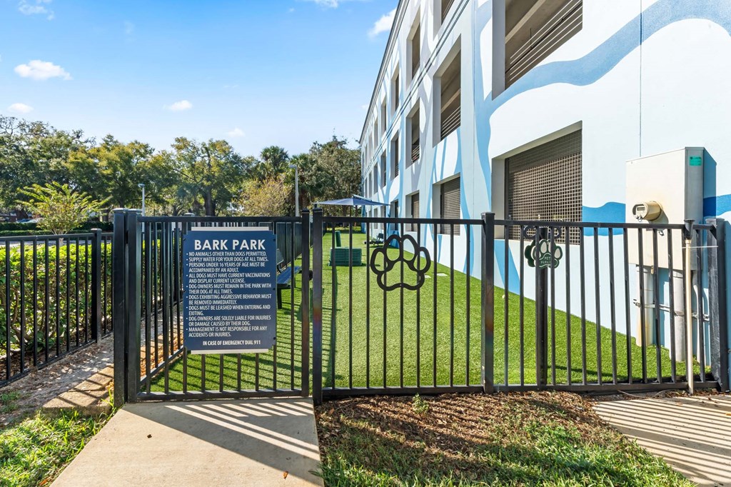 A sign at the entrance to Bark Park provides information about the dog park.