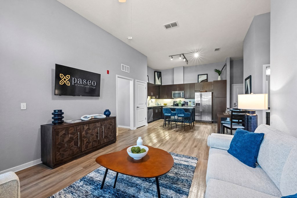 A living room with a white couch and a wooden coffee table.