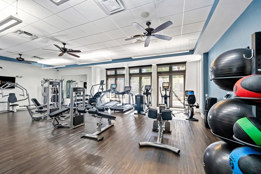 A gym with a variety of equipment including weights and machines.