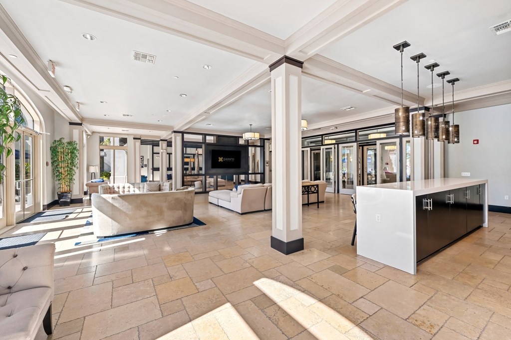 A spacious lobby with a reception desk and seating area.