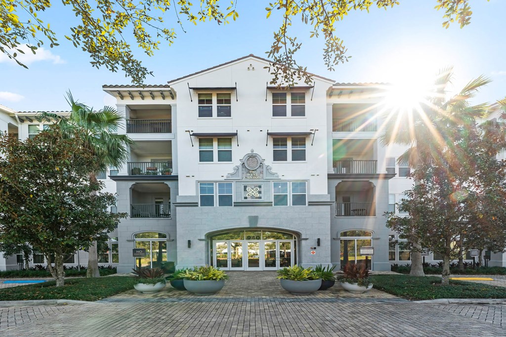 A sunny day at a modern apartment complex with a pool.