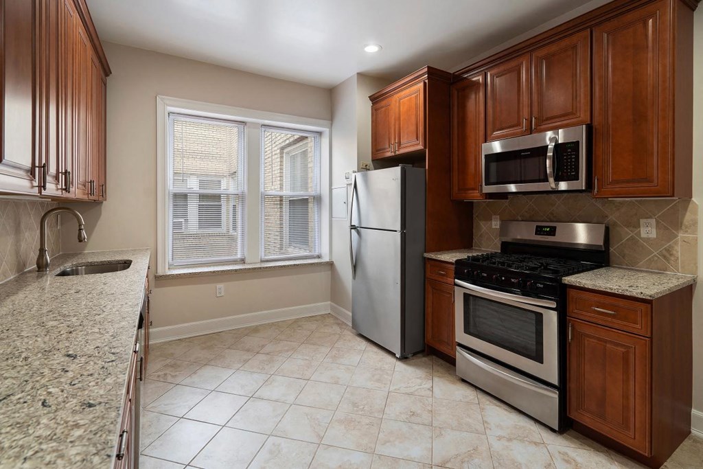 a kitchen with stainless steel appliances and wooden cabinets