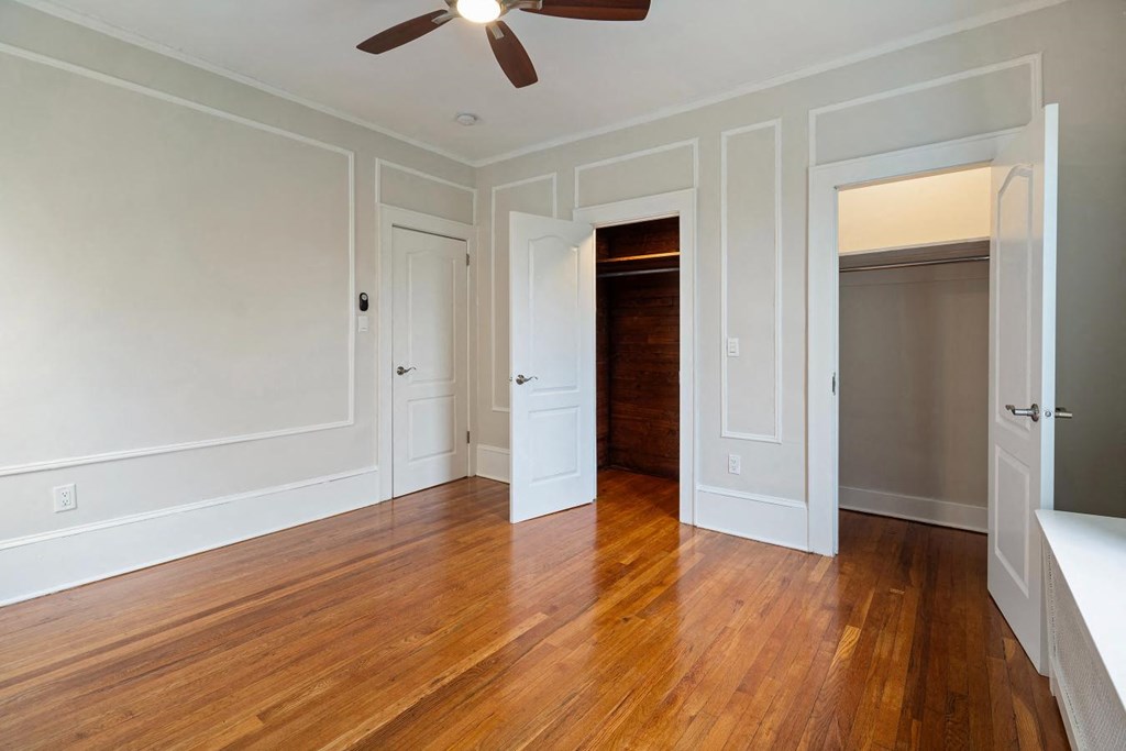 a living room with a wood floor and a closet