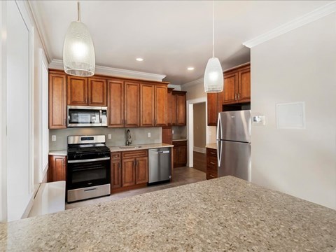 A kitchen with wooden cabinets and stainless steel appliances.