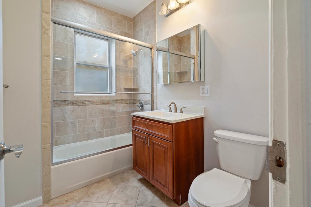 a bathroom with a toilet sink and shower