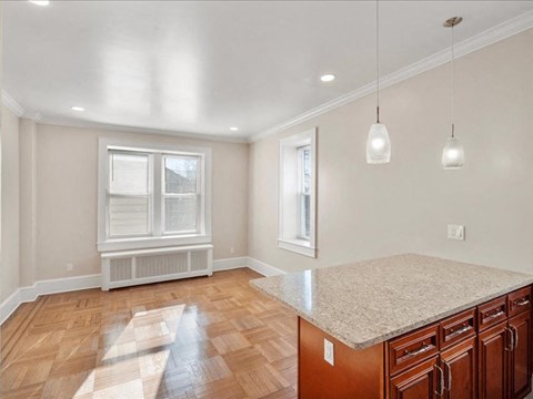 A kitchen with wooden floors and a countertop.