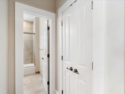 A white door with a silver handle is on the right side of the image.