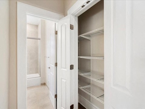 A white refrigerator with its door open in a room.