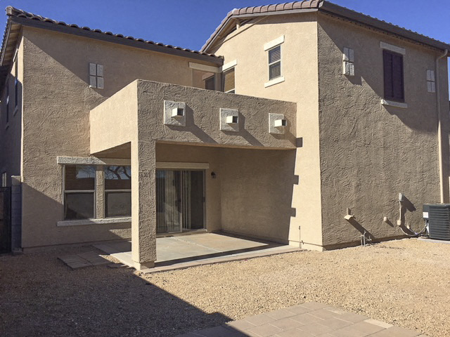 a brick building with a door and a glass door