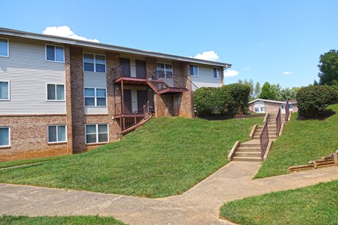 an apartment building on a hill with stairs
